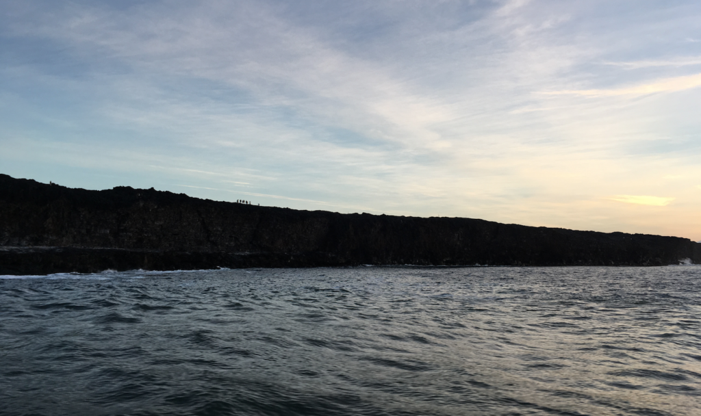 You can see the silhouette of a group of hikers standing on the edge of the cliff. Our captain said that what they were doing was extremely dangerous because the cliffs are unstable. Just recently a 7 acre area of the cliff face collapsed and lives were lost.